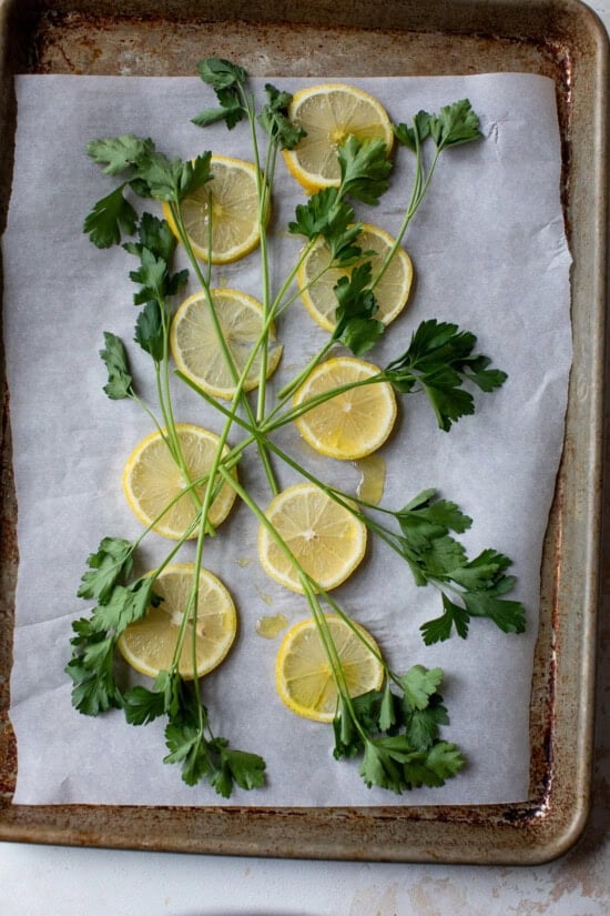 lemons and parsley on a sheet pan