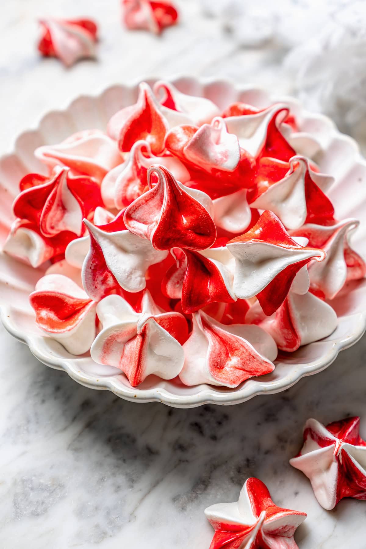 Light and airy peppermint meringues are the perfect addition to any holiday cookie tray! They're surprisingly easy to make and always a hit. Peppermint meringue cookies in bowl