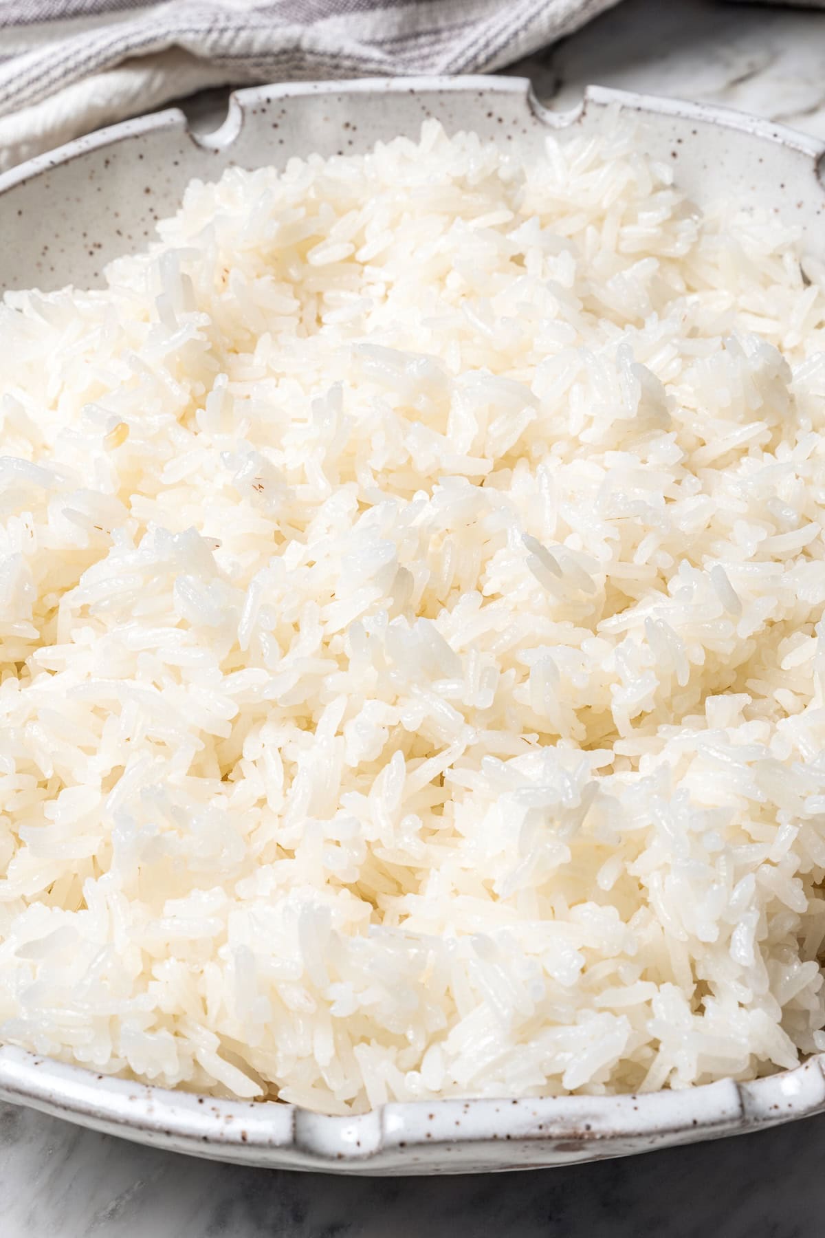 Jasmine rice is a fragrant rice perfect for pairing with curries and stir fries! Make it in the Instant Pot and it's easy, fluffy, and tasty. Bowl of fluffy jasmine rice