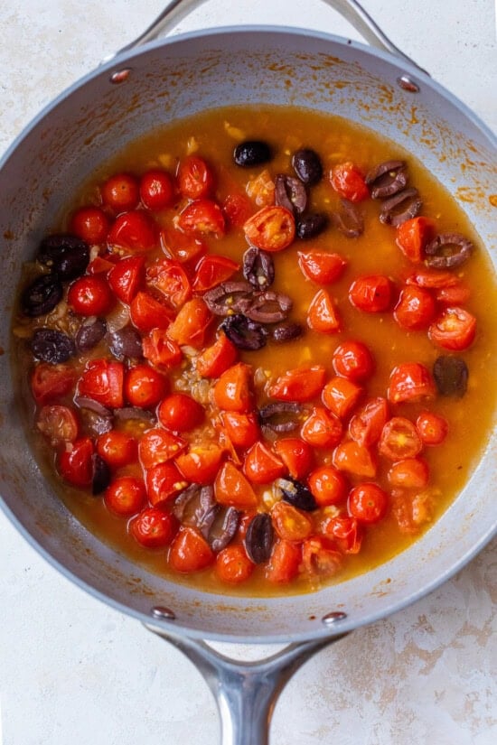 Tomatoes and olives in a skillet