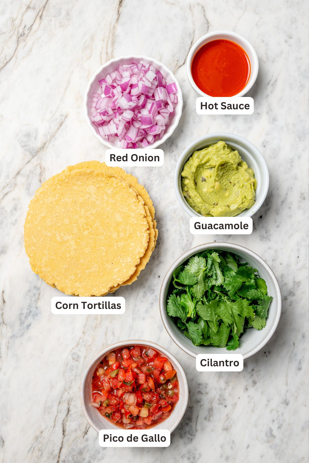 Overhead view of tortillas and toppings for lentil tacos