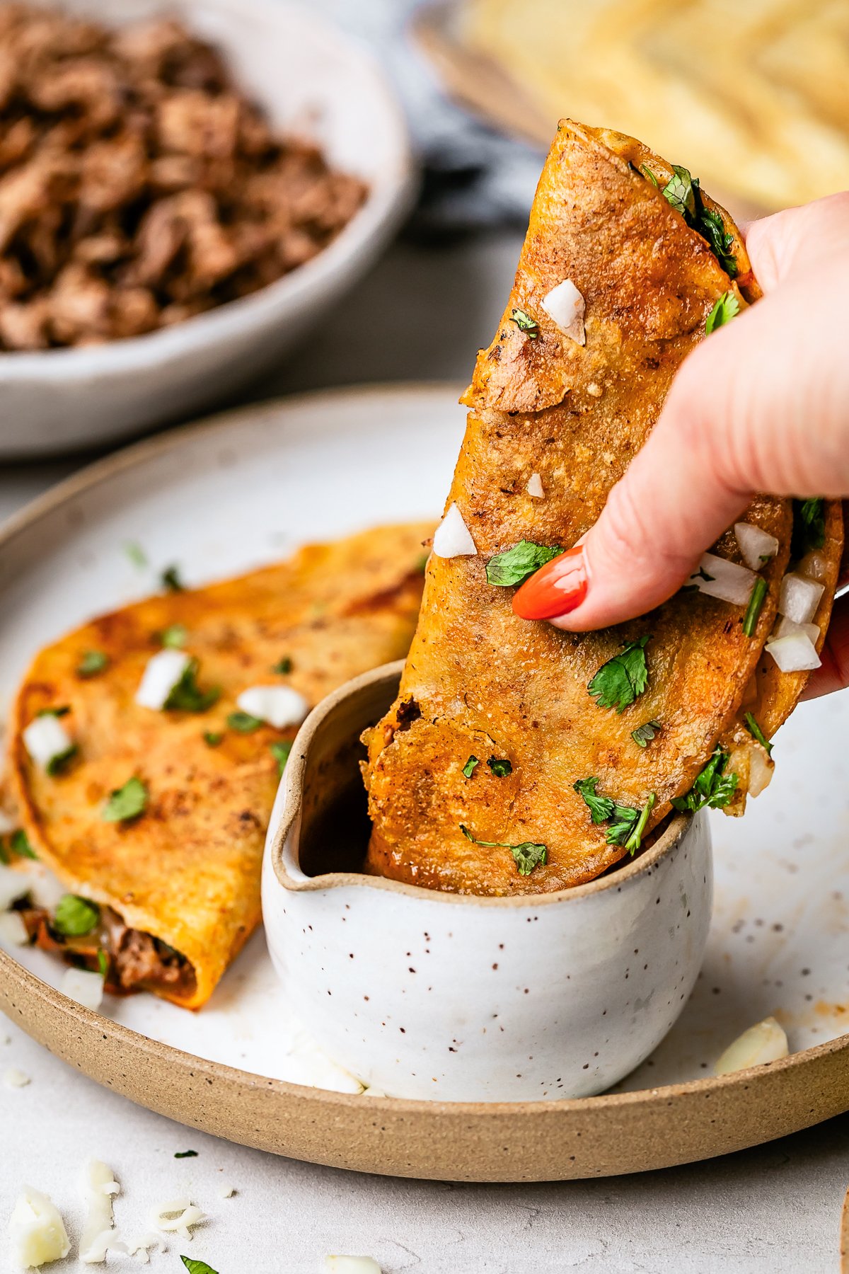 Birria Tacos dipped in consommé
