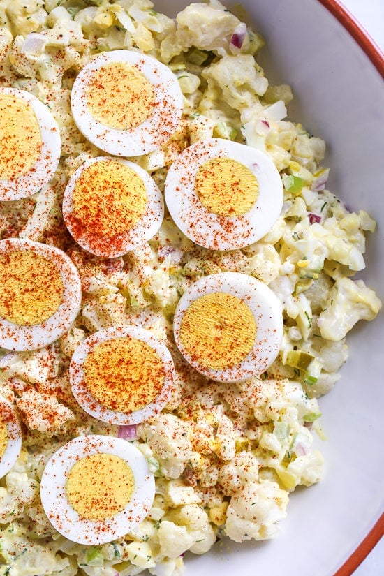 A low-carb faux "potato" salad made with cauliflower instead of potatoes, perfect for Keto or if you're just looking to eat less carbs.