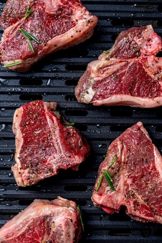 Overhead view of raw lamb chops on grill pan