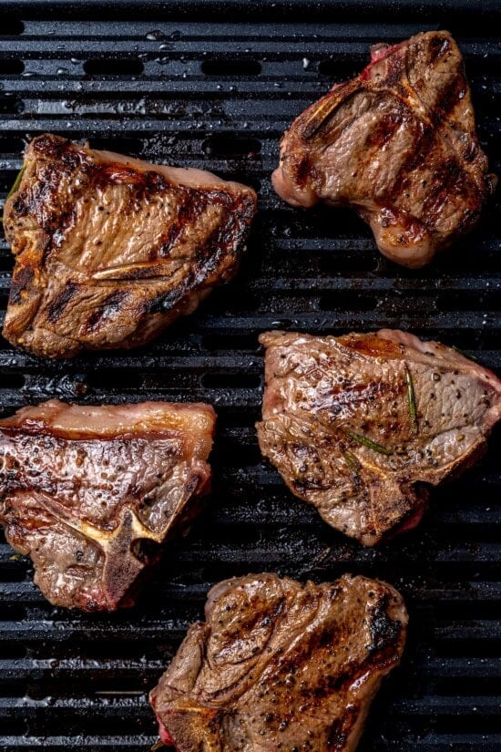 Overhead view of grilled lamb chops on grill pan