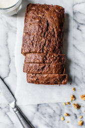 Overhead view of sliced Chocolate Zucchini Bread loaf on white marble