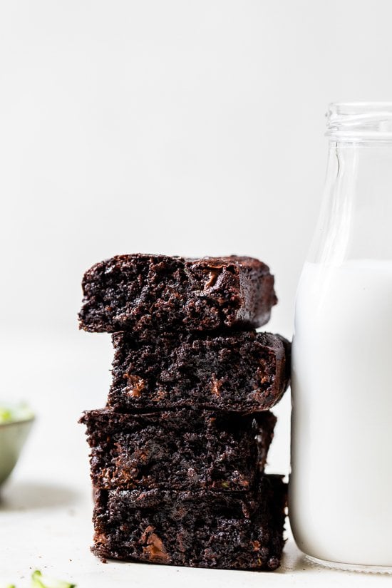 Stack of 4 Flourless Zucchini Brownies with a bottle of milk