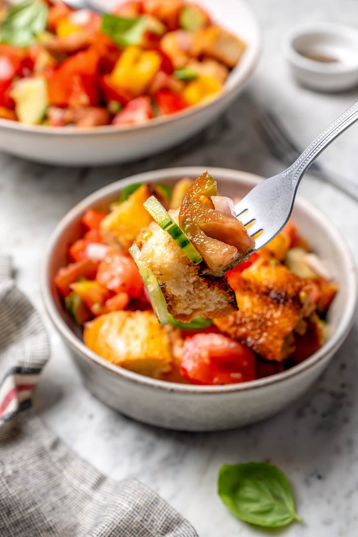 Forkful of panzanella held over bowl
