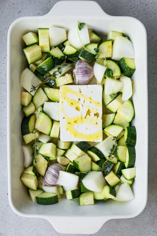baking dish with zucchini, feta, garlic