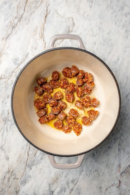 Overhead view of chorizo cooking in Dutch oven