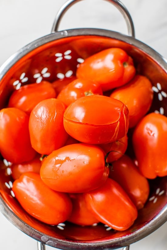 Blanch the tomatoes to remove the skin