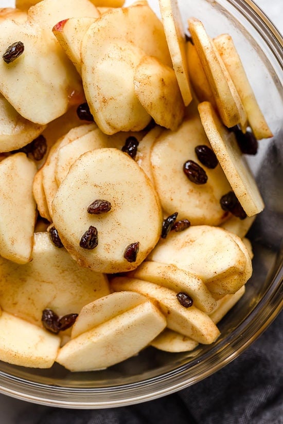 Sliced Honeycrisp apples mixed with cinnamon and raisins for apple crisp filling
