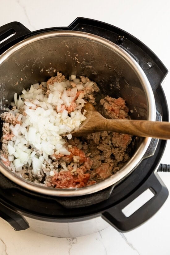 Add onions and garlic to the instant pot.