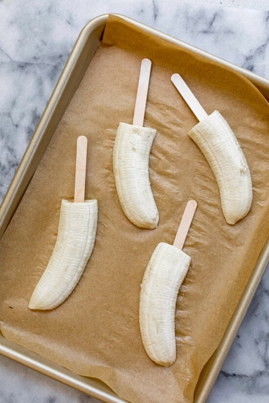 Cut bananas, insert sticks and freeze