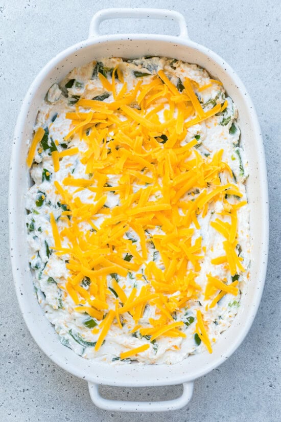Pour the mixture into an 8x8-inch baking dish and top with cheese