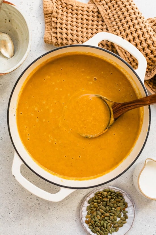 Cozy dairy-free pumpkin soup with fresh ginger, mushrooms, and coconut milk