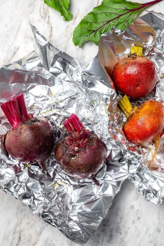 This Roasted Beet and Citrus Salad pairs tender beets with creamy goat cheese, citrus fruit and pistachios for a show-stopping holiday side! Red beets and golden beets each on separate sheets of foil.