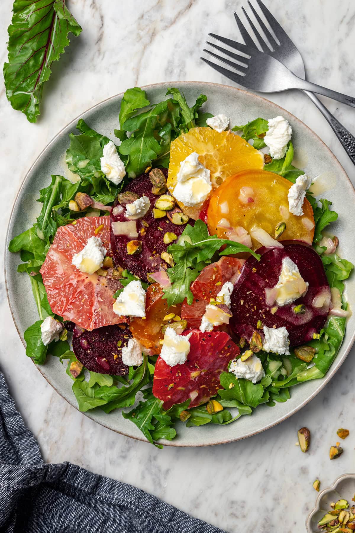 This Roasted Beet and Citrus Salad pairs tender beets with creamy goat cheese, citrus fruit and pistachios for a show-stopping holiday side! Roasted beet salad with citrus fruit, goat cheese, and pistachios.