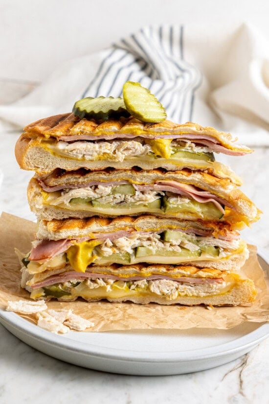 Stack of leftover turkey Cuban sandwiches on plate