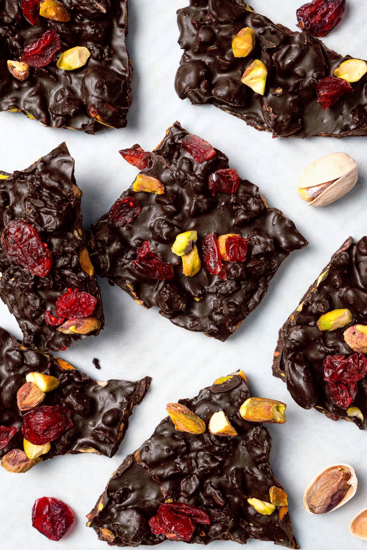Pistachio and cranberry dark chocolate bark on countertop.