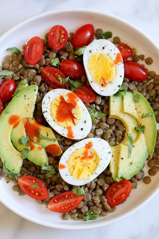 Lentils with hard boiled eggs, tomatoes, avocado, a squeeze of lime juice, cilantro and a few dashes of hot sauce is a really simple meatless lunch I like to make for myself anytime I have cooked lentils (or sometimes I buy them cooked).