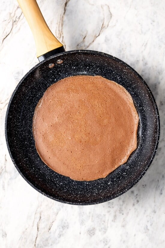 Chocolate crepe in skillet.