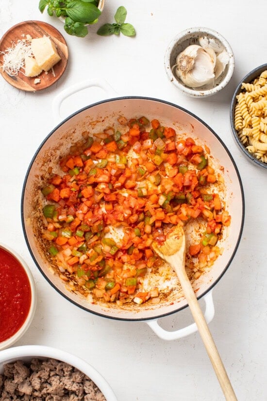 sauteing veggies and tomato paste in skillet