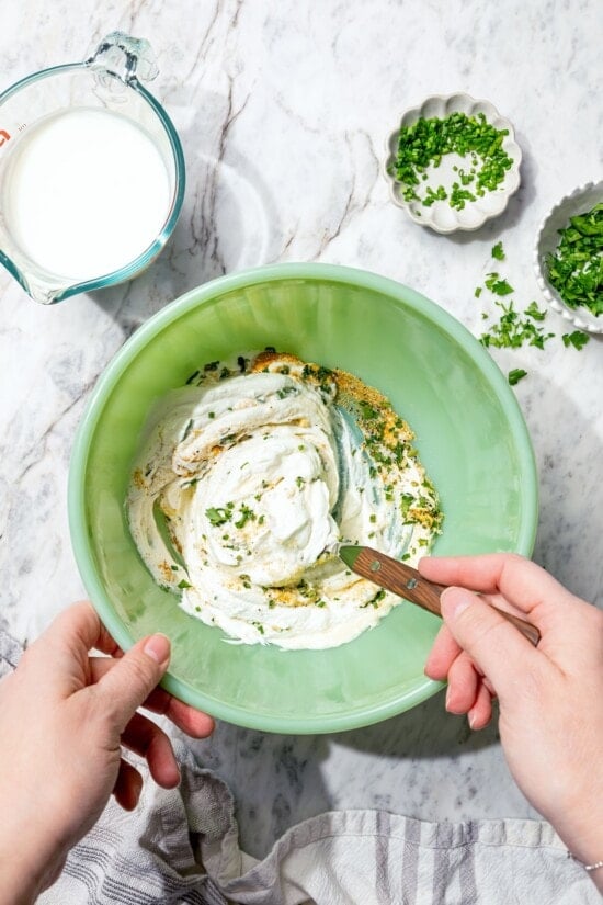 Stirring together ingredients for buttermilk ranch dressing.