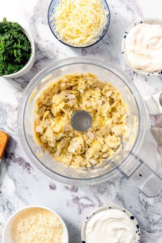 Spinach Artichoke Dip with artichokes in the food processor.