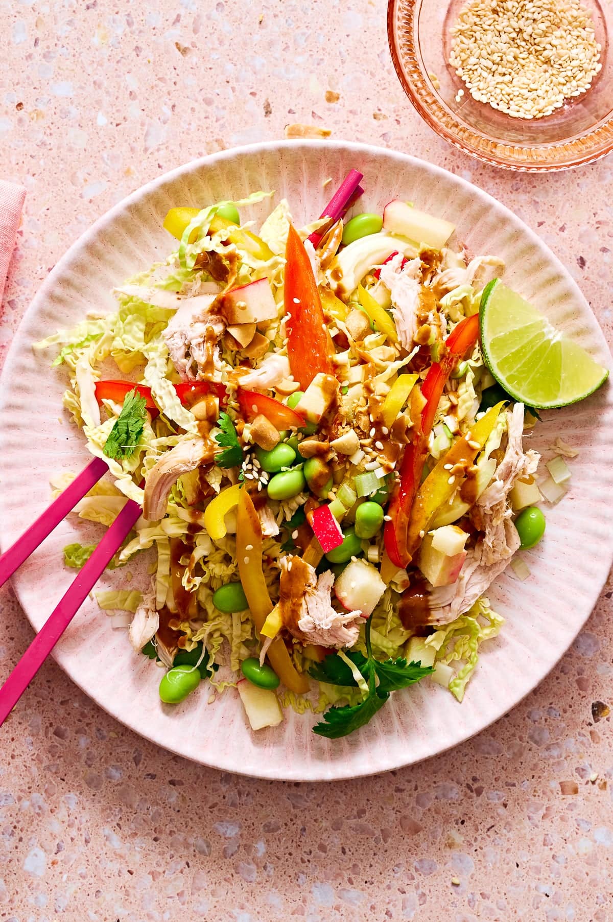 This high-protein, Thai-inspired chicken salad features crunchy slaw, edamame, fresh herbs, roasted peanuts, and a light peanut-lime dressing—perfect for lunch or meal prep.
