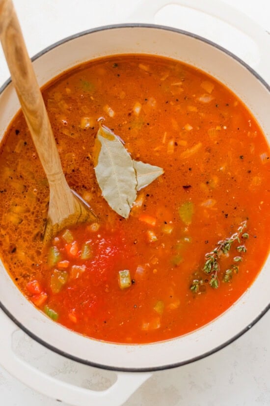 Tomatoes, bay leaves in a pot